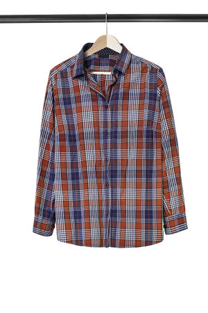 Cotton tartan shirt hanging on clothes rack isolated over whiteの写真素材
