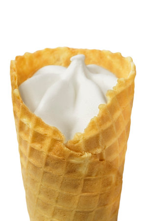 Vanilla ice cream in waffle cone closeup isolated over whiteの写真素材