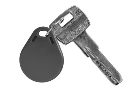Scratched steel and plastic magnetic keys isolated on white backgroundの写真素材