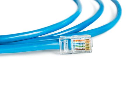 Blue ethernet cable rj-45 plug connector closeup isolated over whiteの写真素材