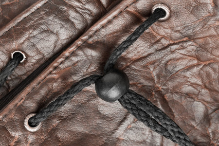 No tie lace lock in brown leatherette bag closeup