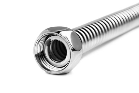 Stainless steel flexible water nut connector hose lying isolated over whiteの写真素材