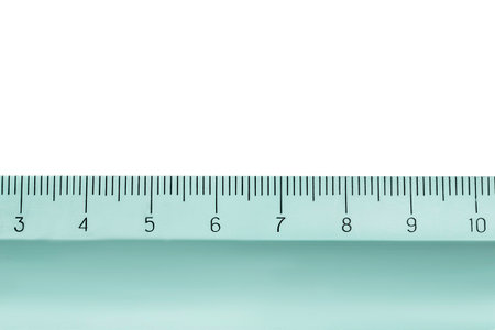 Part of plastic metric ruler closeup isolated on white backgroundの写真素材