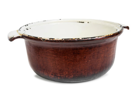 Empty old iron oven pot isolated on white backgroundの写真素材