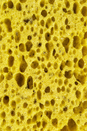 Yellow kitchen sponge texture closeup as a backgroundの写真素材