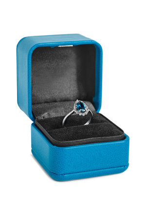 Sapphire ring in blue jewel box isolated on white background