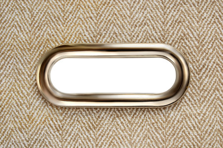Metal hand hole ellipse protector in beige fabric closeupの写真素材