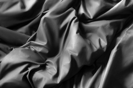 Black cotton crumpled blanket details closeup as abackgroundの写真素材