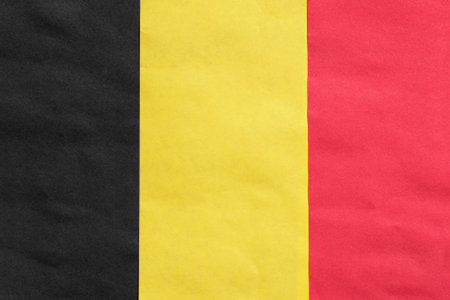 Paper national Belgian tricolor flag closeup as a backgroundの写真素材