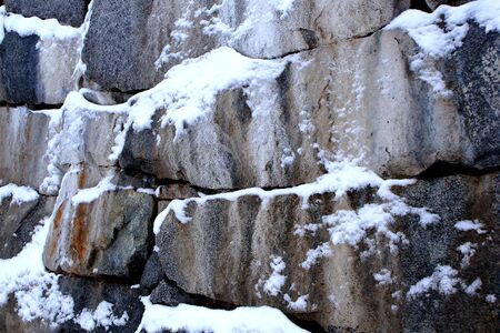Snow in a stone wall in Moere Parkの写真素材