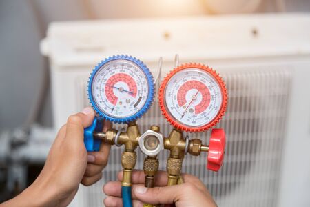 Technician is checking air conditioner ,measuring equipment for filling air conditioners.の写真素材
