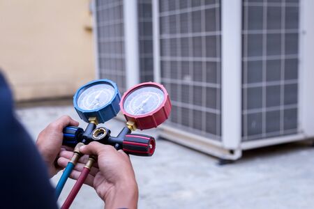 Technician is checking air conditioner ,measuring equipment for filling air conditioners.の写真素材
