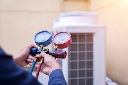 Technician is checking air conditioner ,measuring equipment for filling air conditioners.の写真素材