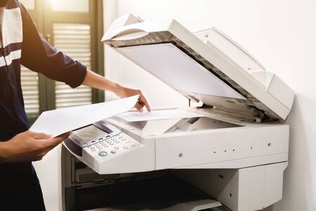 Business people keypad hand on the panel printer, printer, scanner, laser copier, office equipment, concept, start workingの写真素材