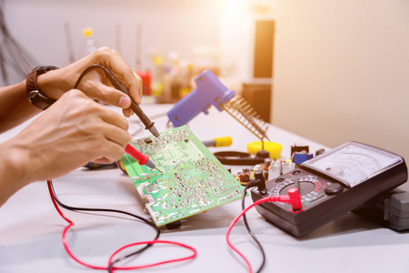 Close up of the hand men hold tool repairs electronics manufacturing Services,Repair of electronic...