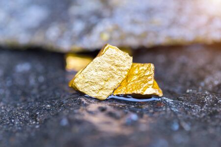 Gold on the stone floor Discovering Success and Investing Concepts with Business Partners.の写真素材