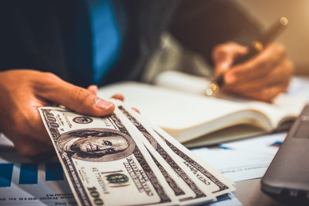 Businessman with money in hand, US dollar,investment, success and profitable business concepts.