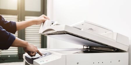 Business people keypad hand on the panel printer, printer, scanner, laser copier, office equipment, concept, start workingの写真素材