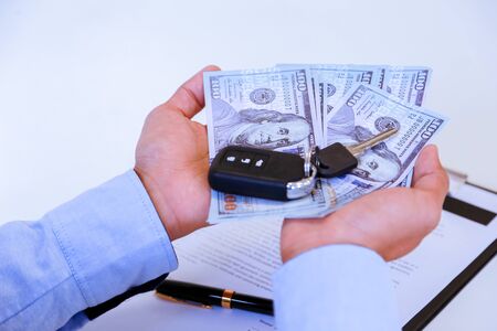 Successful businessman offering a car key with contract.Rental agreement for a car with contract.Car Insurance.の写真素材