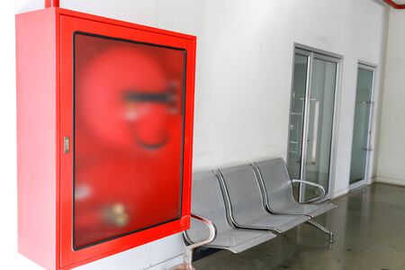 Fire extinguisher and fire hose reel in building corridor.の写真素材