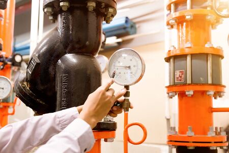 Engineer checking Condenser Water pump and pressure gauge , chiller water pump with pressure gauge.System ready.の写真素材