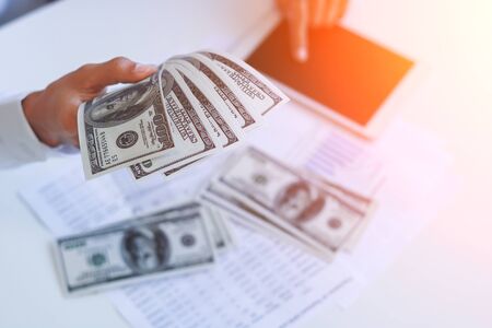 Businessman with cash dollars - business concept,tablet and finance,investment,save.の写真素材
