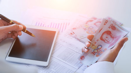 Businessman with cash yuan - business concept,tablet and finance,investment,save.