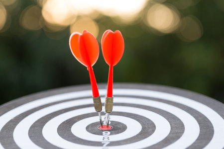 Red dart target arrow hitting on bullseye with,Target marketing and business success conceptの写真素材