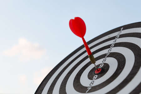 Red dart target arrow hitting on bullseye with,Target marketing and business success conceptの写真素材