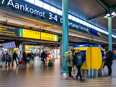 SCHIPHOL AMSTERDAM AIRPORT, NETHERLANDS - JANUARY 15, 2015: Tourists and travellers at Schiphol Amsterdam Airport train terminal, Netherlandsのeditorial素材