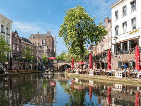 UTRECHT, NETHERLANDS - MAY 21, 2015: Oudaen Castle and people on outdoor terrace of restaurants alongside Oudegracht canal in the city of Utrecht, Netherlandsのeditorial素材