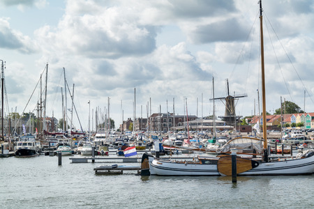 HELLEVOETSLUIS, NETHERLANDS - AUG 25, 2015: Yachts and windmill in the harbour of Hellevoetsluis, Netherlandsのeditorial素材