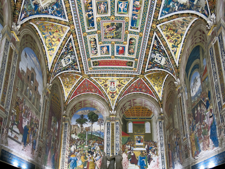 SIENA, ITALY - JULY 27, 2013: Interior of Duomo di Siena or Siena Cathedral.  Piccolomini Library with frescoes painted by Umbrian Bernardino di Betto, called Pinturicchioのeditorial素材