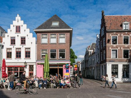 UTRECHT, NETHERLANDS - MAY 21, 2015: People on outdoor terrace and bicyclist on Korte Minrebroederstraat - city life in Utrecht, the Netherlandsのeditorial素材