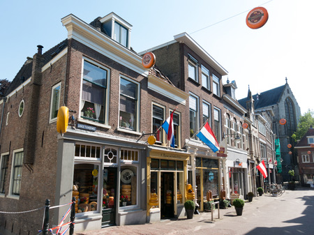 GOUDA, NETHERLANDS - JUNE 10, 2015: Shopping street with shops selling Dutch cheese in the historic city centerのeditorial素材