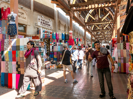 Sellers and shops in the ancient covered textile souq Bur Dubai in the old city centre of Dubai, United Arab Emiratesのeditorial素材