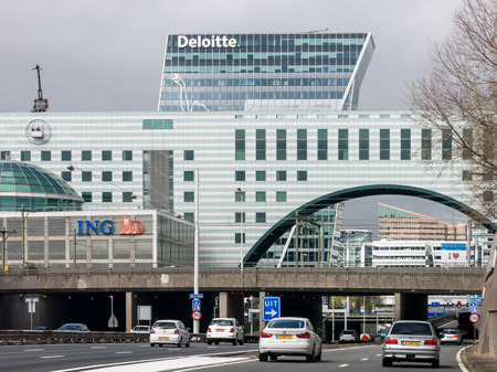 Traffic on motorway A12 also called Utrechtsebaan,  and modern buildings in The Hague, Netherlands