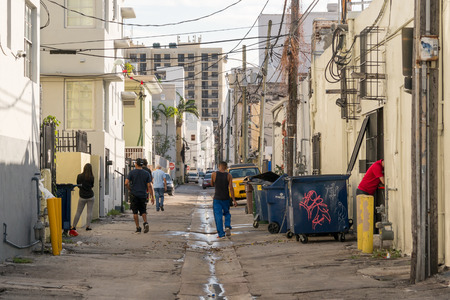 Street scene with local people, cars and waste containers in Collins Court in South Beach district of Miami Beach, Florida, USAのeditorial素材