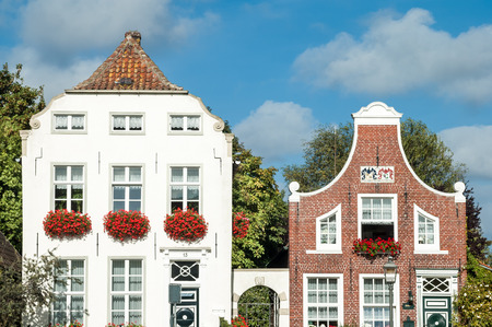 Facades of historic houses of Sielstrasse in the fishing harbour of Greetsiel, Lower Saxony, Germanyのeditorial素材