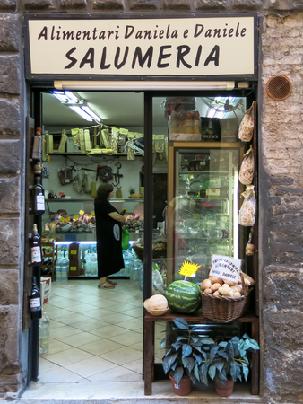 Typical Tuscan grocery shop in narrow street Via Tito Sarrocchi, Siena, Tuscany, Italyのeditorial素材