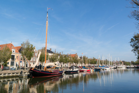 Noorderhaven canal with boats and houses in historic old town of Harlingen, Friesland, Netherlandsのeditorial素材