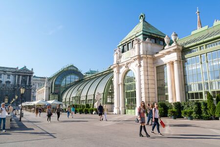 People walking in front of Palm House in Burggarten gardens in downtown Vienna, Austriaのeditorial素材