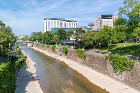 Vienna river and people on patio of Steirereck restaurant in Stadtpark, City Gardens, in Vienna, Austriaのeditorial素材