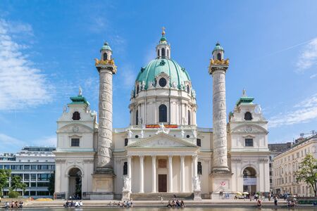 People relaxing near pool in front of Karlskirche (Charles Church) on Karlsplatz in Vienna, Austriaのeditorial素材
