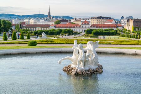 Pool with baroque sculpture in Belvedere gardens and Lower Belvedere Palace in Vienna, Austriaのeditorial素材