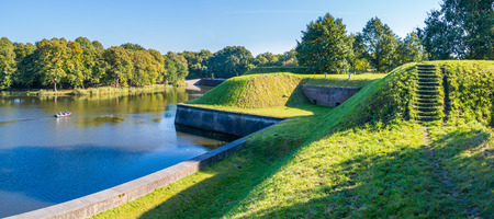 Bastion Oranje and people in boat cruising on moat of old fortified town of Naarden, North Holland, Netherlandsのeditorial素材