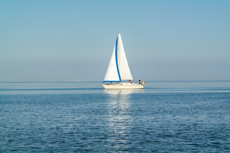 WADDENSEA, NETHERLANDS - SEP 13, 2016: Sailboat sailing at calm and sunny Waddensea, Netherlandsのeditorial素材