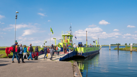 TIENGEMETEN, NETHERLANDS - MAY 20, 2017: Passengers entering ferry boat leaving Tiengemeten island in Haringvliet estuary, South Holland, Netherlandsのeditorial素材