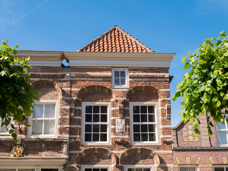 WOUDRICHEM, NETHERLANDS - JUN 4, 2017: Front top facade of historic house  Hoogstraat 9 with cornice gable in old town of fortified city Woudrichem, Brabant, Netherlandsのeditorial素材
