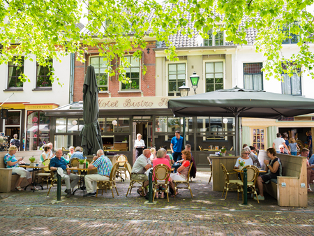 WIJK BIJ DUURSTEDE, NETHERLANDS - JUN 11, 2017: People relaxing on outdoor terrace of cafe on market square in old town of Wijk bij Duurstede in province Utrecht, Netherlandsのeditorial素材